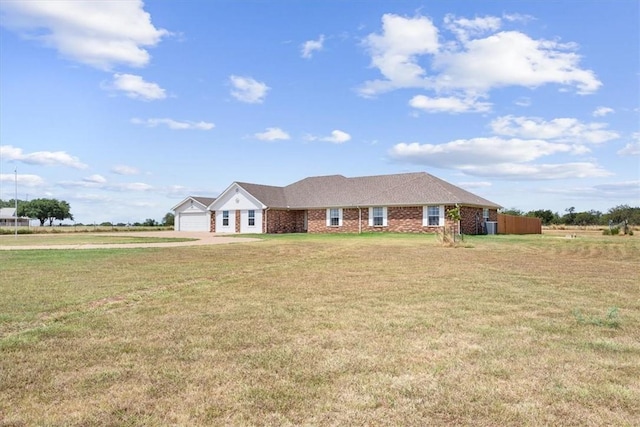 single story home with brick siding, a garage, and a front lawn