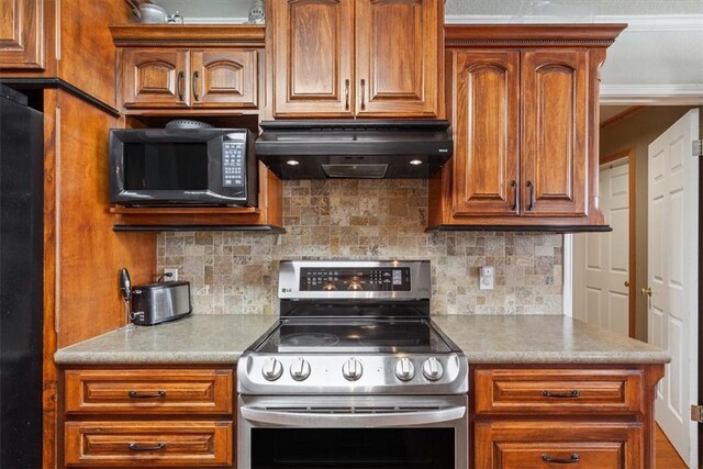 kitchen featuring backsplash, fridge, stainless steel electric range, black microwave, and extractor fan