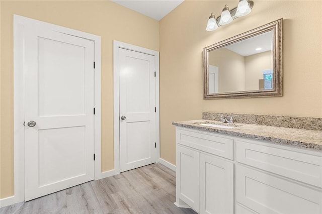 bathroom with vanity and wood-type flooring