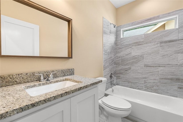 full bathroom with vanity, toilet, and tiled shower / bath