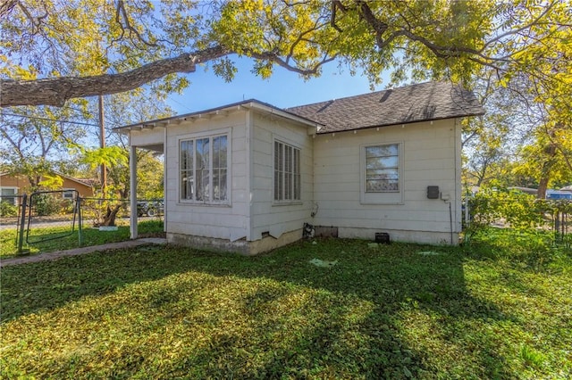 back of property with a lawn