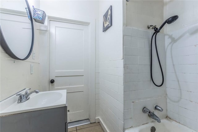 bathroom featuring tile patterned floors, vanity, and tiled shower / bath