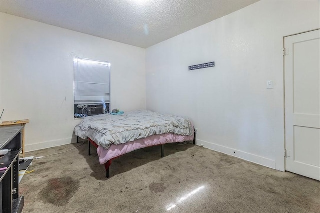 carpeted bedroom featuring cooling unit and a textured ceiling