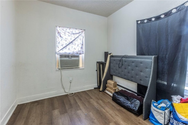 bedroom featuring wood-type flooring and a textured ceiling