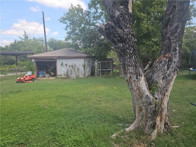 view of yard with an outdoor structure and a trampoline