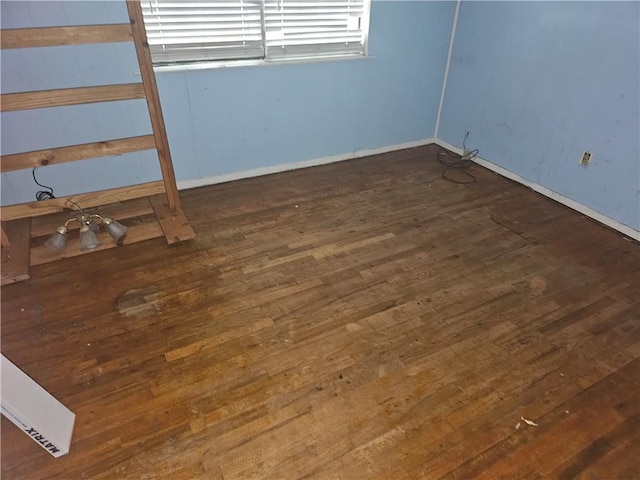 spare room featuring dark wood-type flooring