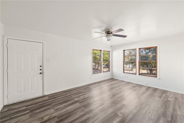 spare room featuring ceiling fan and dark wood-type flooring