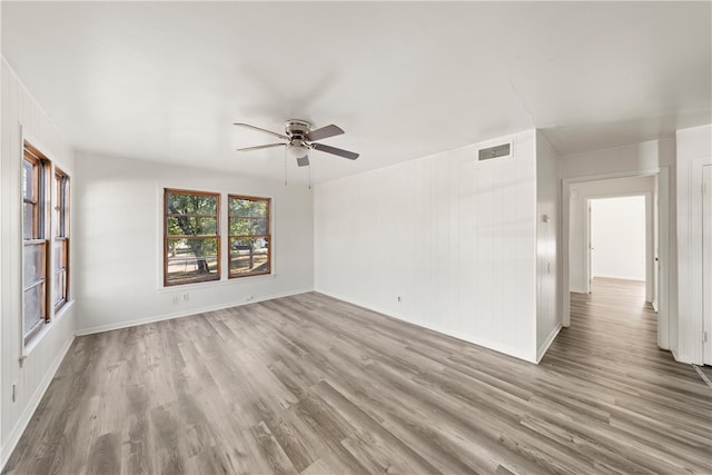 spare room featuring ceiling fan and light hardwood / wood-style flooring