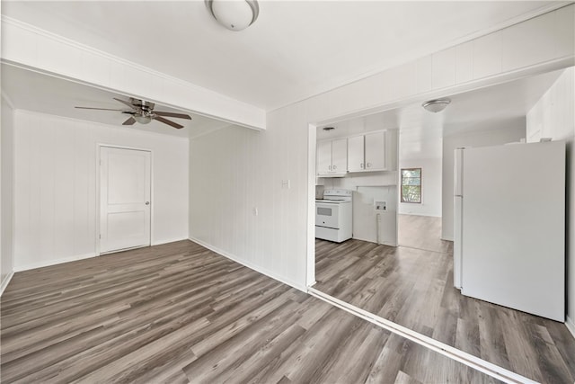 unfurnished living room with beamed ceiling, ceiling fan, and wood-type flooring