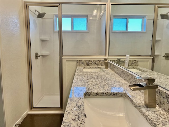 bathroom featuring vanity and a shower with door