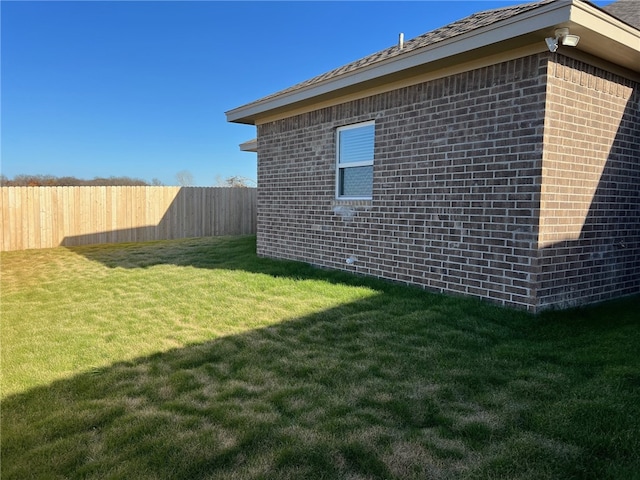 view of side of home featuring a yard