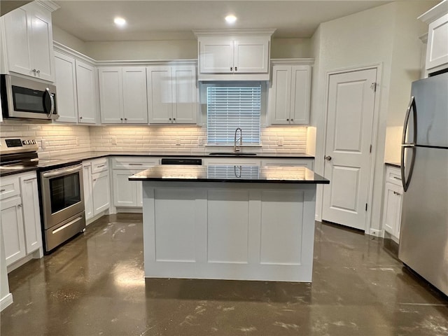 kitchen with decorative backsplash, sink, white cabinetry, and stainless steel appliances