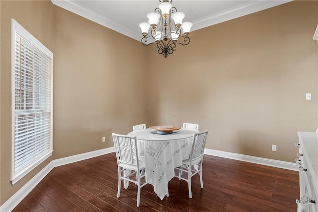 dining space featuring ornamental molding, dark hardwood / wood-style flooring, and an inviting chandelier