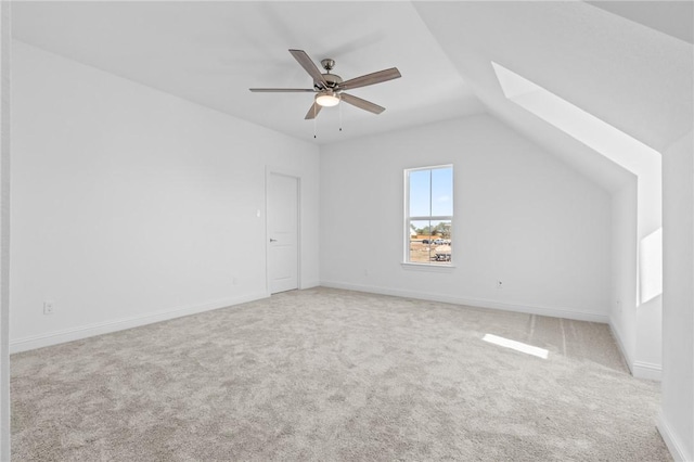 bonus room with ceiling fan, light colored carpet, and vaulted ceiling