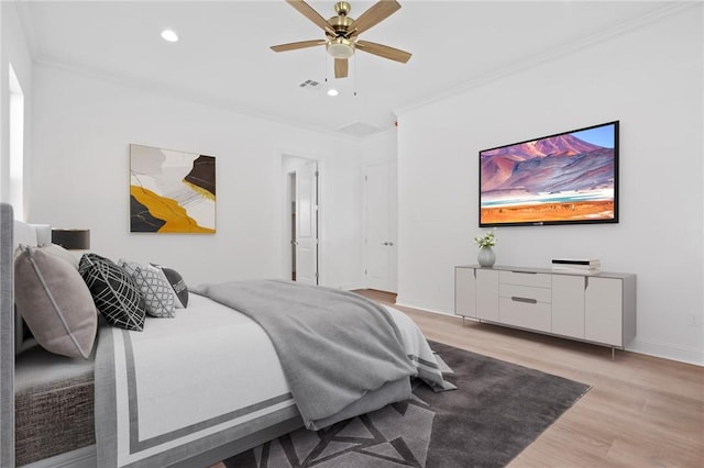 bedroom with ceiling fan, light hardwood / wood-style flooring, and ornamental molding