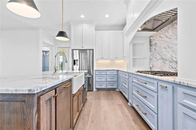 kitchen with hanging light fixtures, tasteful backsplash, light stone counters, white cabinetry, and stainless steel gas cooktop