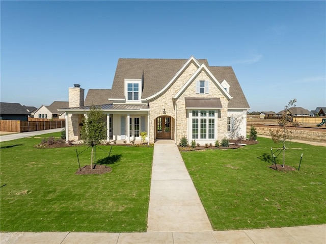 view of front of home featuring a porch, french doors, and a front yard