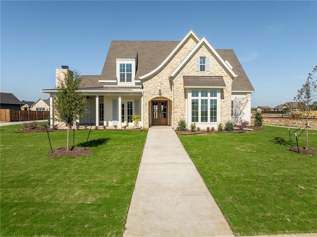 view of front of home with a front yard and french doors