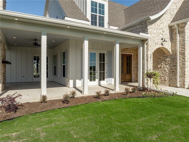 doorway to property with a lawn, a patio area, ceiling fan, and french doors