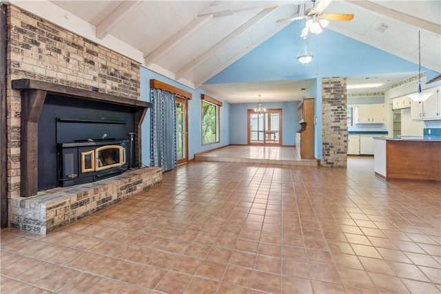 unfurnished living room featuring beamed ceiling, light tile patterned floors, ceiling fan with notable chandelier, and high vaulted ceiling