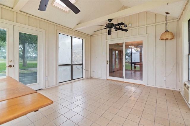 unfurnished sunroom with ceiling fan and lofted ceiling with skylight