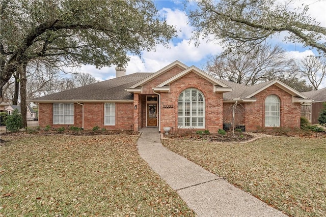 ranch-style home with a front lawn