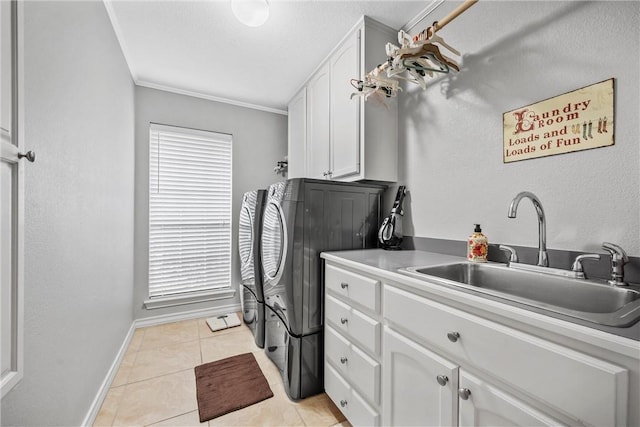 washroom featuring cabinets, sink, light tile patterned floors, and washer and clothes dryer