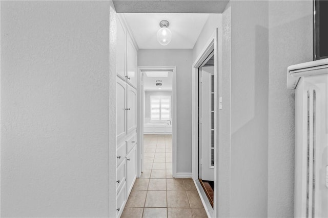 hallway featuring light tile patterned floors