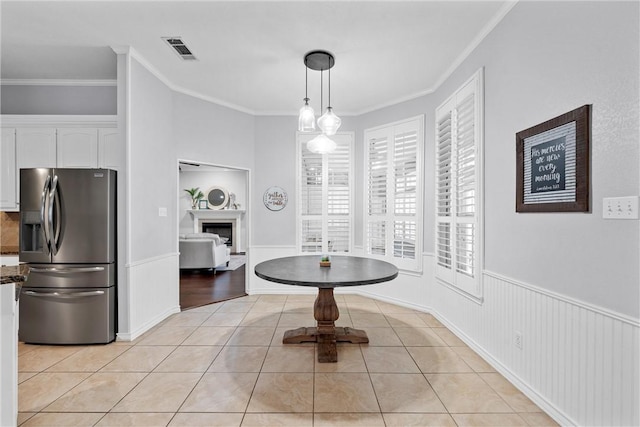 interior space featuring light tile patterned floors and crown molding