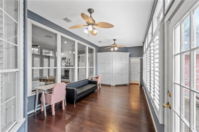 interior space featuring dark hardwood / wood-style flooring, a wealth of natural light, and ceiling fan