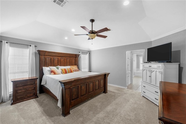 carpeted bedroom featuring vaulted ceiling, ceiling fan, crown molding, and a tray ceiling