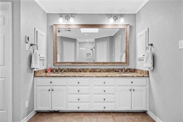 bathroom featuring a tile shower, vanity, and crown molding