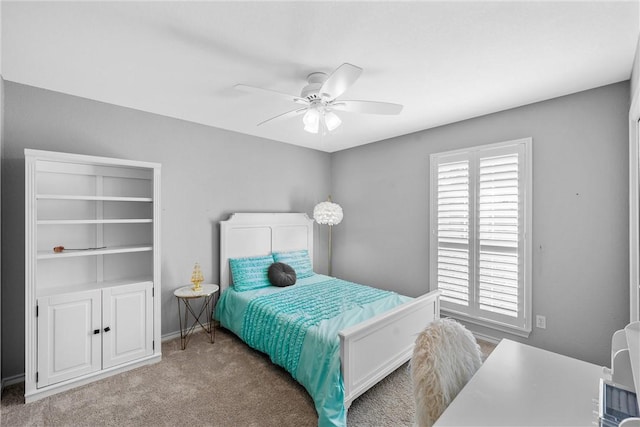 bedroom featuring light colored carpet and ceiling fan