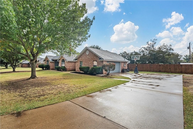 ranch-style house featuring a front lawn and a garage