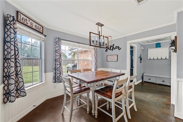 dining room with crown molding and an inviting chandelier