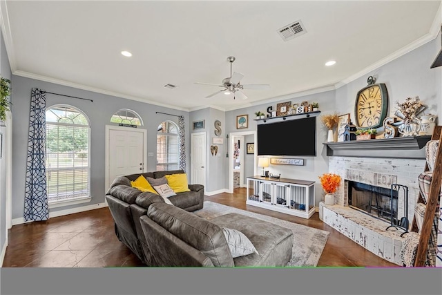 living room featuring a fireplace, ceiling fan, and crown molding