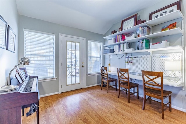 interior space with lofted ceiling, light hardwood / wood-style floors, and a healthy amount of sunlight