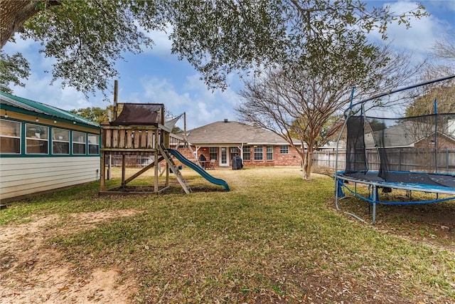 view of yard featuring a playground and a trampoline