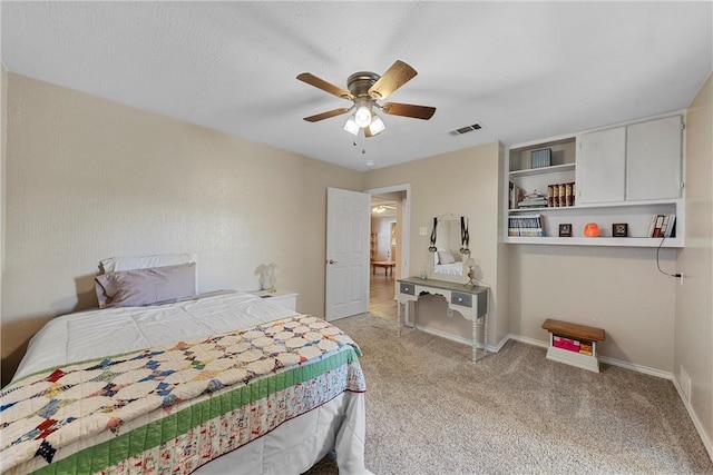 bedroom with ceiling fan and light carpet