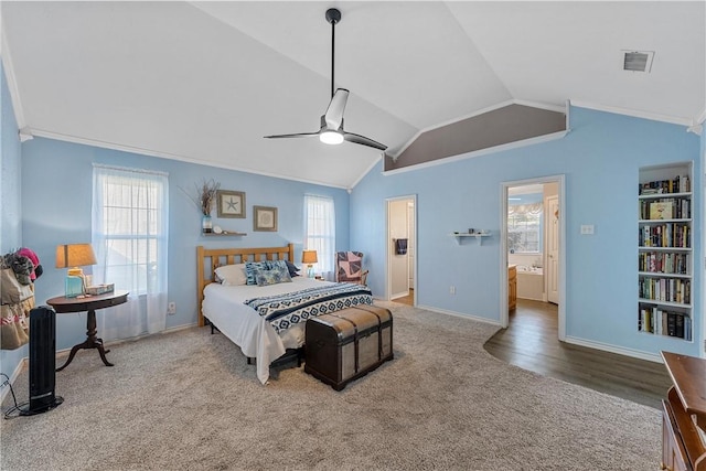 bedroom featuring ceiling fan, ensuite bathroom, hardwood / wood-style floors, lofted ceiling, and ornamental molding