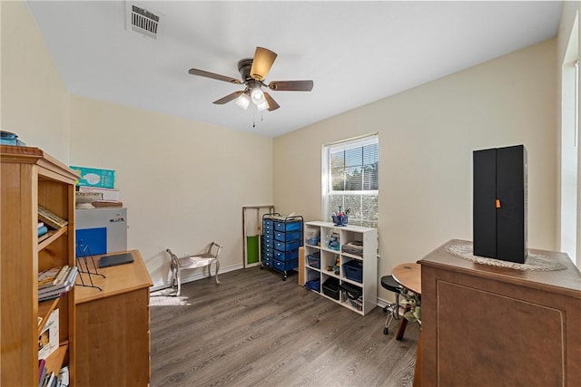 home office featuring ceiling fan and dark wood-type flooring