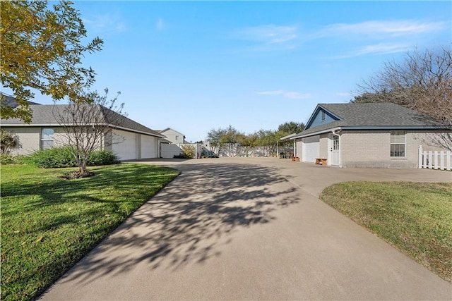 view of property exterior featuring a garage and a lawn