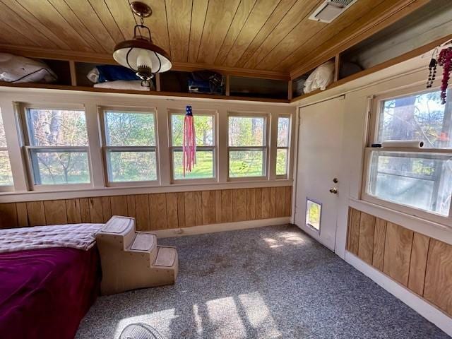 unfurnished sunroom with wood ceiling and a wealth of natural light