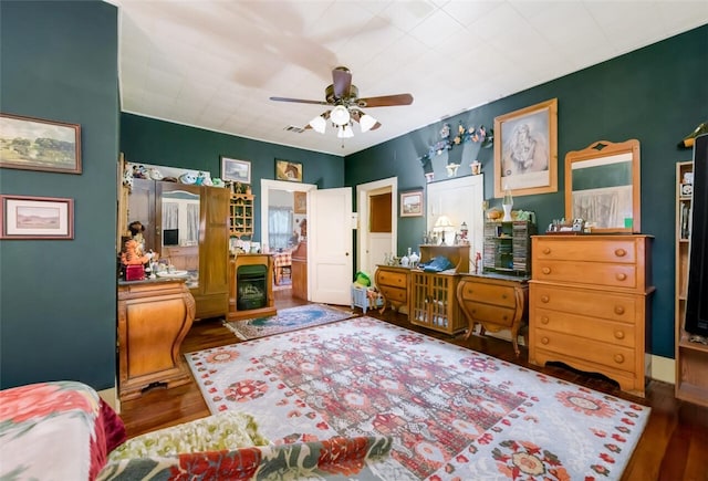 bedroom with dark hardwood / wood-style floors and ceiling fan