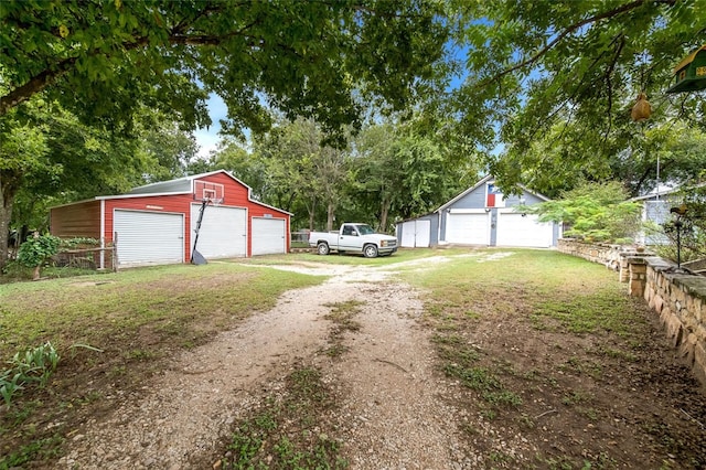 view of yard with a garage and an outdoor structure