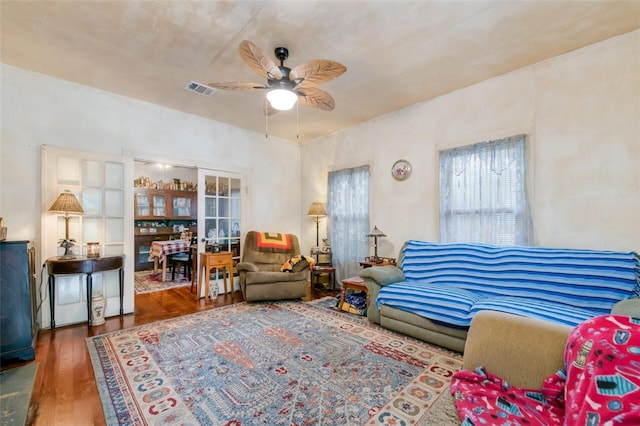 living room with dark hardwood / wood-style floors and ceiling fan