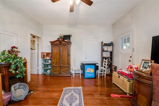 interior space with ceiling fan and dark hardwood / wood-style flooring