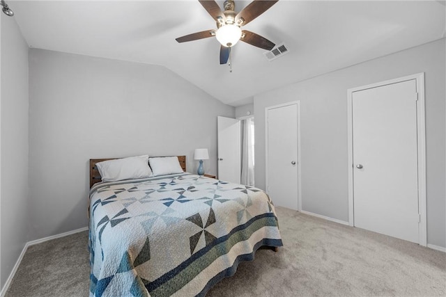 bedroom with baseboards, visible vents, lofted ceiling, ceiling fan, and carpet flooring