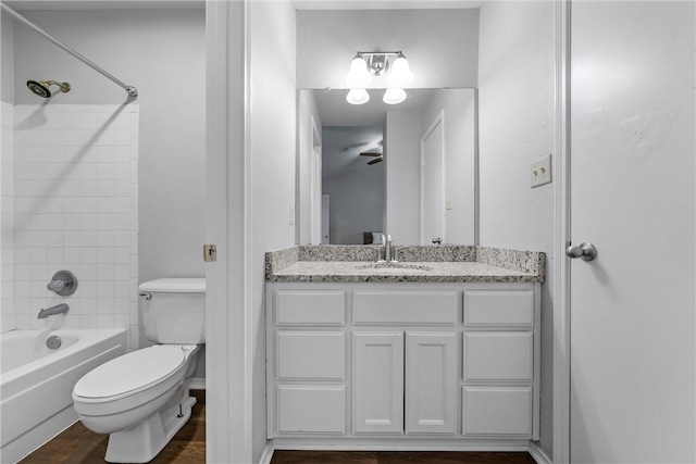 bathroom with vanity, toilet, washtub / shower combination, and ceiling fan