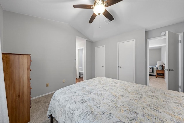 carpeted bedroom featuring visible vents, lofted ceiling, baseboards, and a ceiling fan